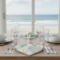 Aqua Coral Linen Napkins Set of 4 arranged on a breezy beach table with a coral motif.