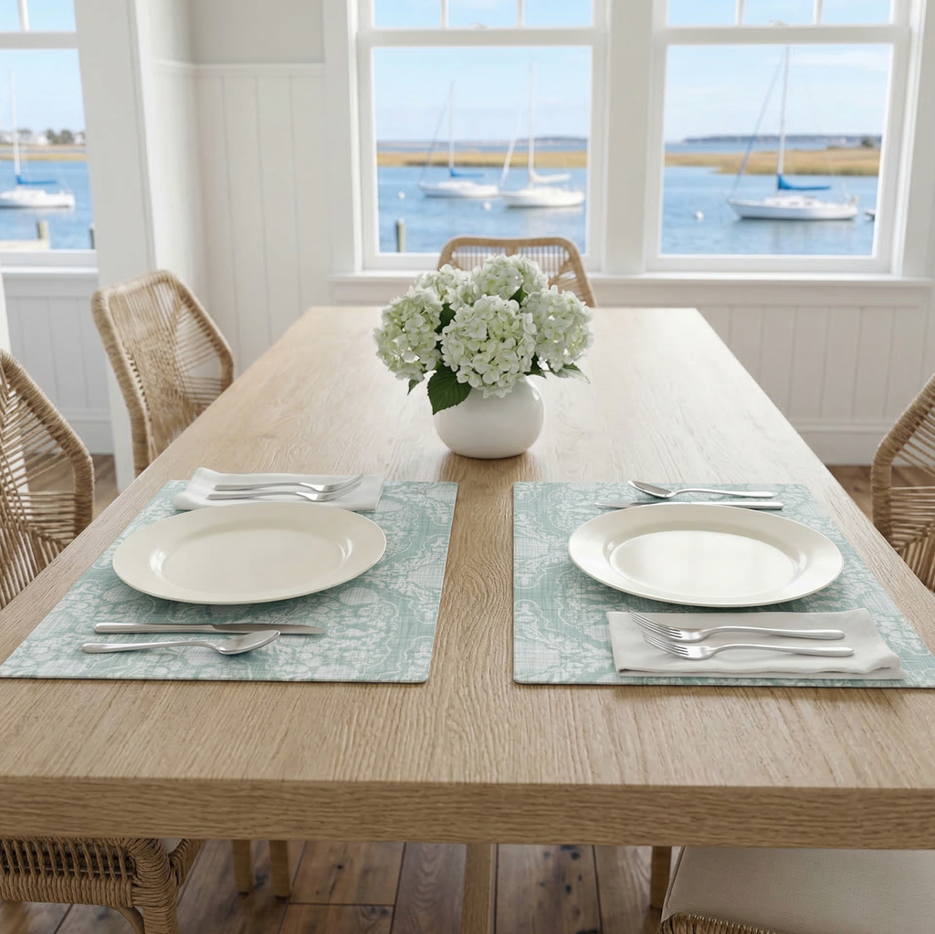 Aqua Seahorse Damask Placemat on a wooden dining table with two place settings and a hydrangea centerpiece.