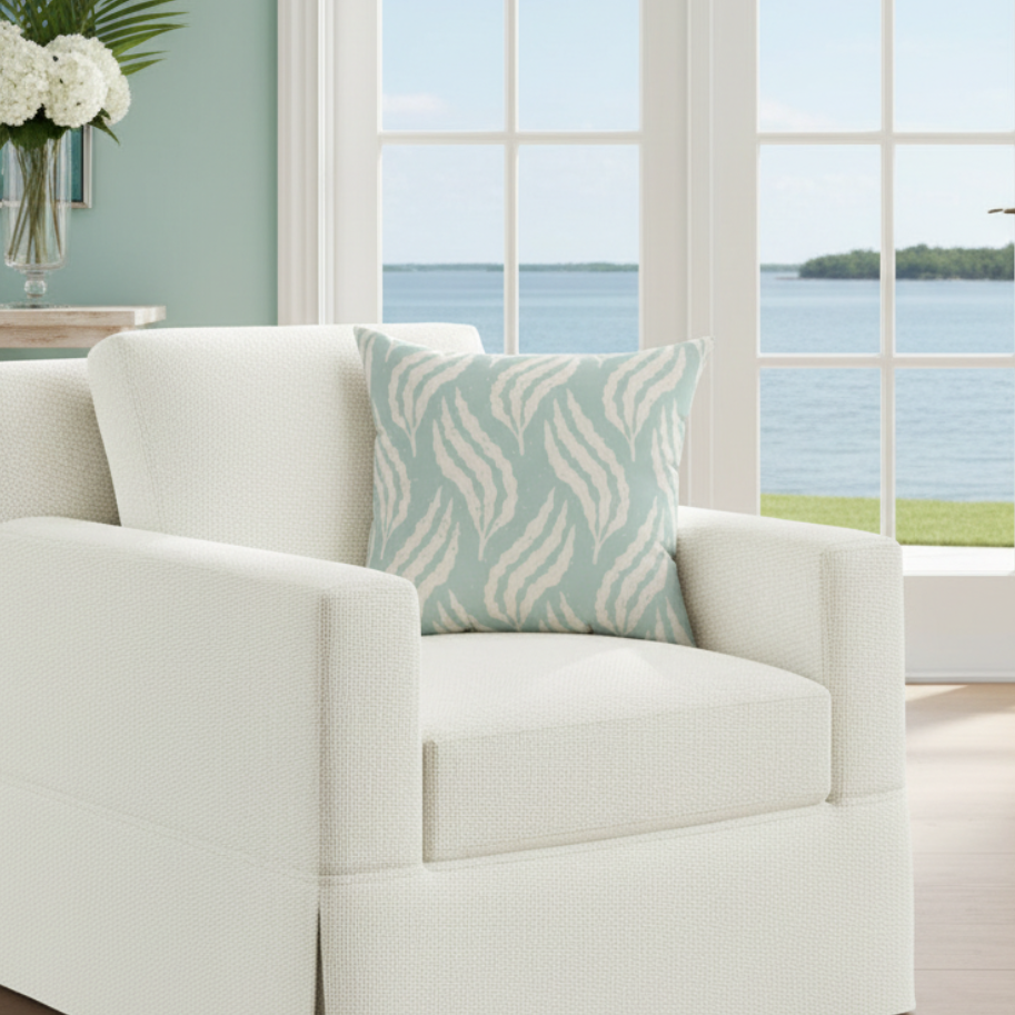 Aqua Leaf Pattern Throw Pillow with seafoam aqua background and cream leaf motif on a white sofa, coastal decor.
