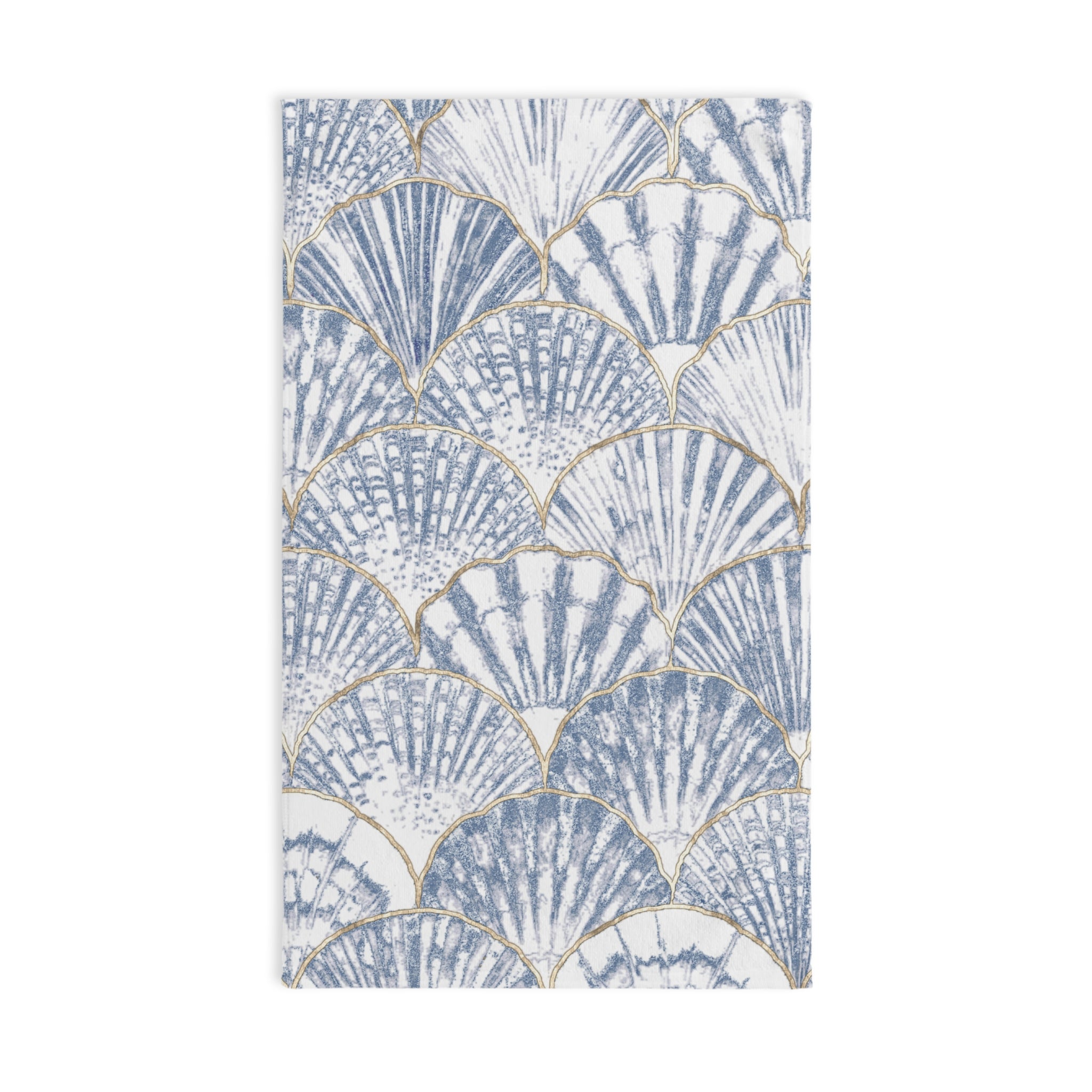 Towel with shell pattern hanging on a towel rack in a bathroom.